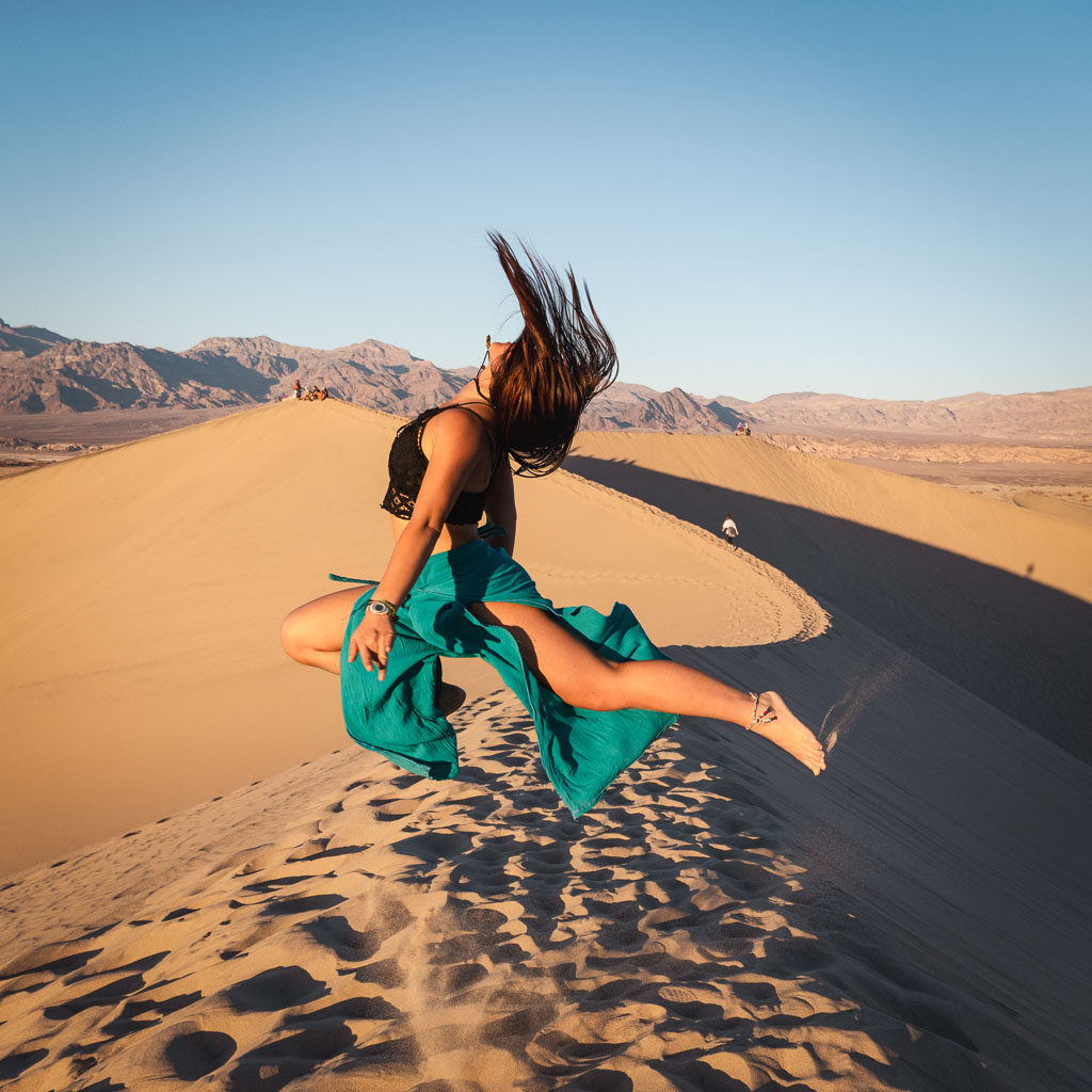 girl jumping in Mesquite Flat Sand Dunes 