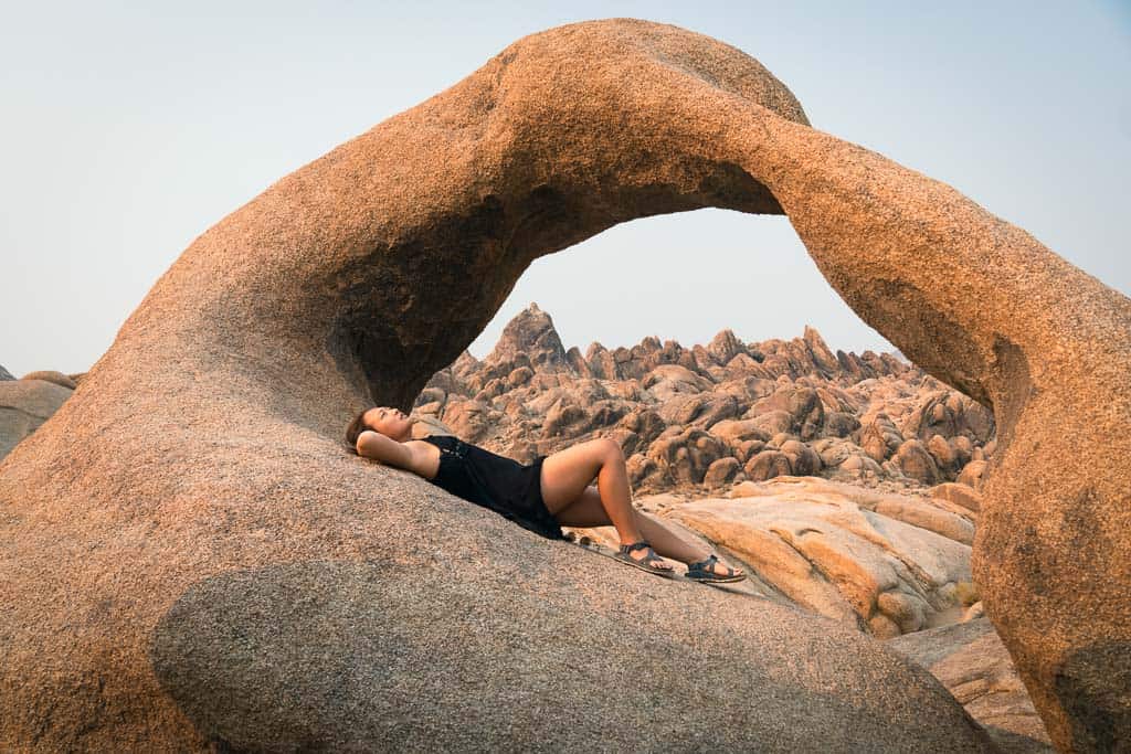 Girl Chilling at Mobius Arch in Alabama Hills on a california desert road trip