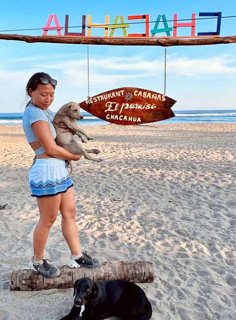 Girl with dogs on the Chacahua beach, Oaxaca