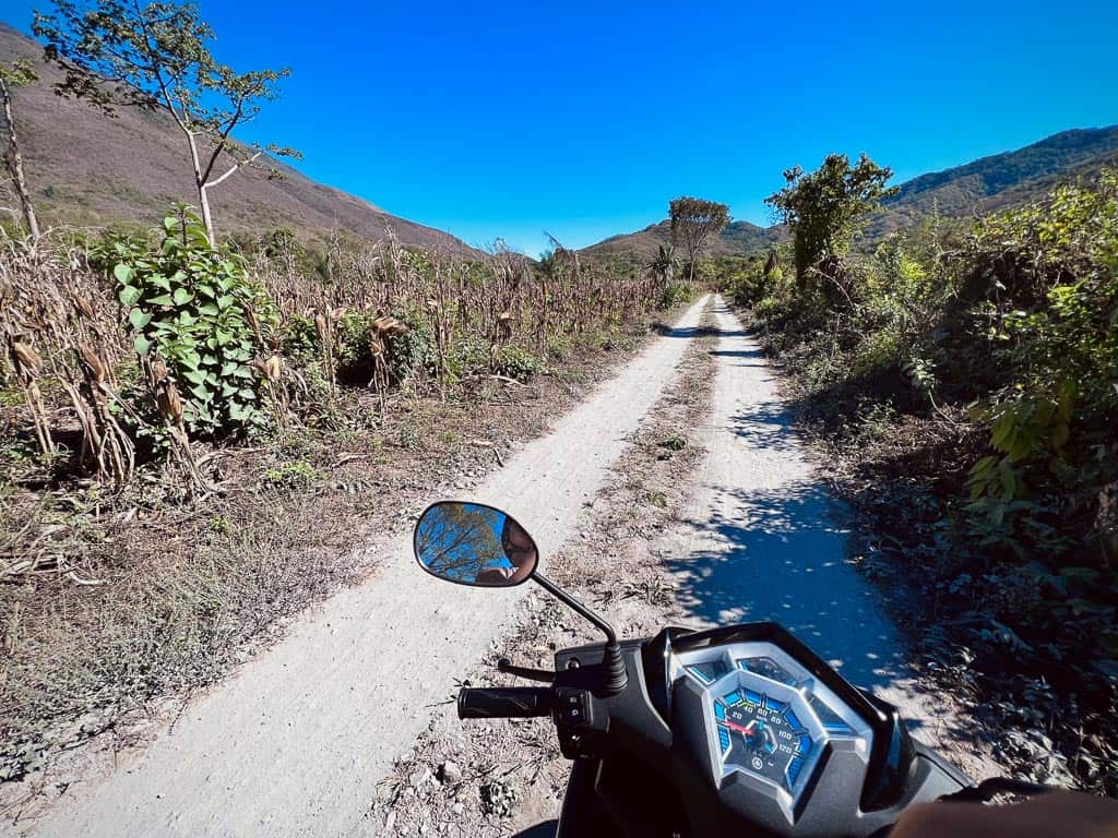 Renting a Scooter riding into nature on dirt road