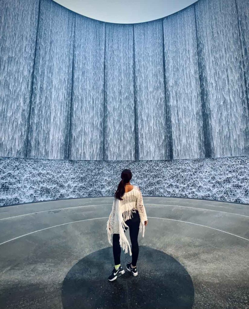 Girl in white at Gerald D. Hines Waterwall Park. Add this to your weekend in houston itinerary