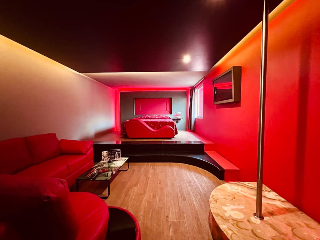 Red Hotel Room with a Pole Dancing Area