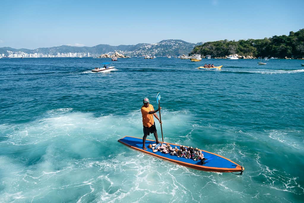 Vendors Selling shells on Paddleboard in Acapulco Bay
