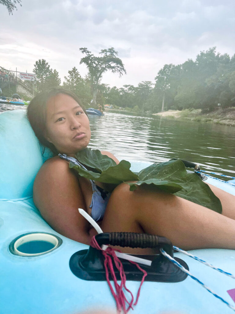 trying to keep warm with a giant lily pad on a chilly thunderstorm day floating the san marcos river