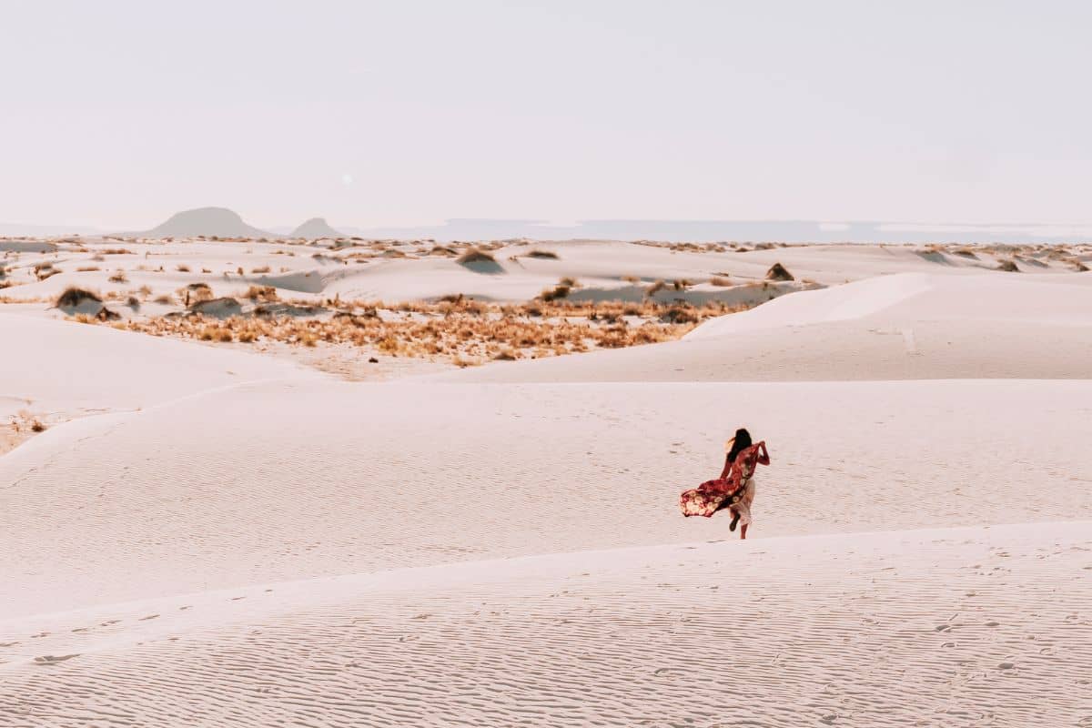 travel blogger in a remote desert fulfilling her bucket list