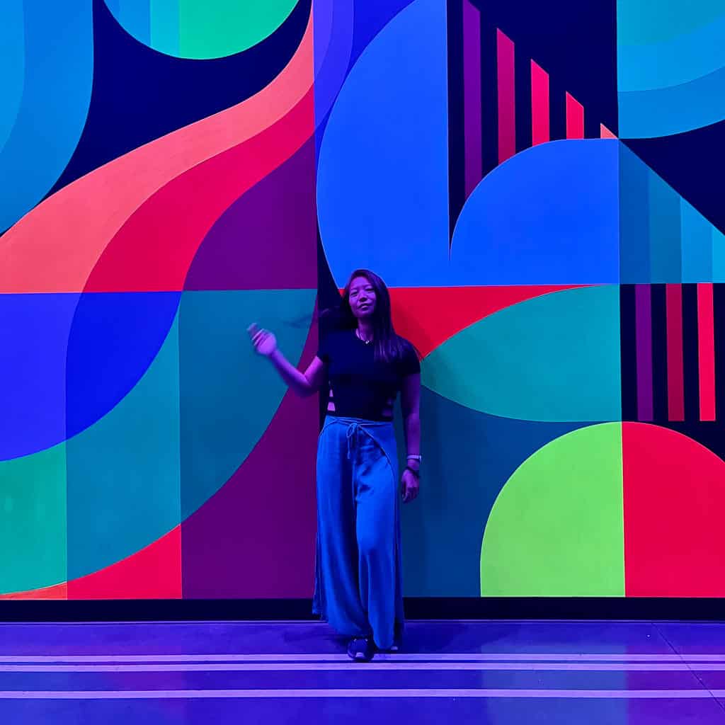Girl in front of colorful wall in Area 15