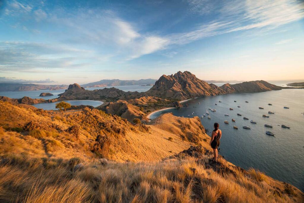 Nomadicated looking out onto the sunrise view of padar island, one of asia's most famous landmarks