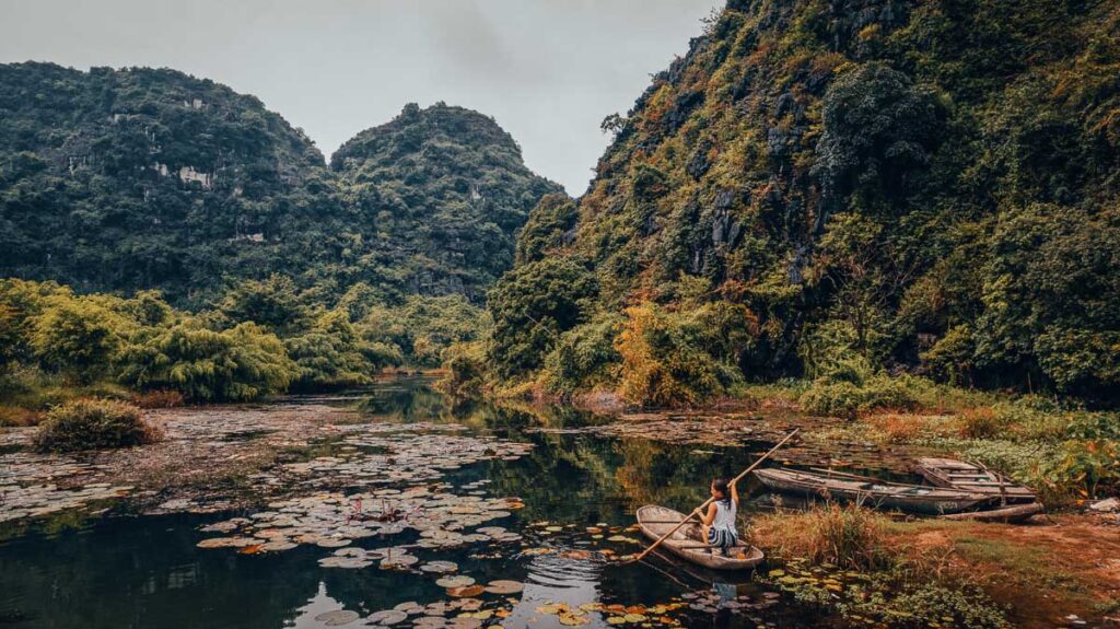catherine xu rowing a boat in a hidden area around ninh binh and tam coc area