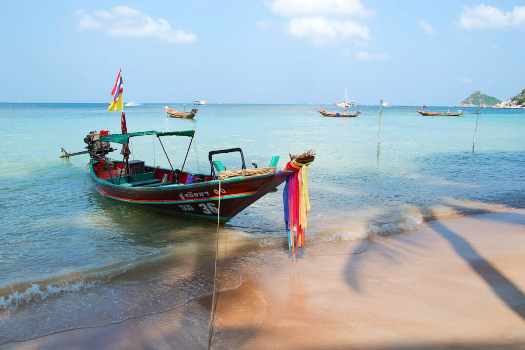 southern thailand beach with a boat