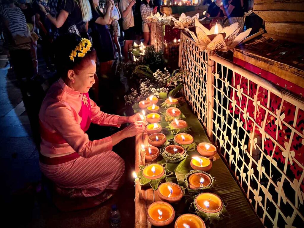 thai people lighting candle during the lantern festival, which thailand is famous for