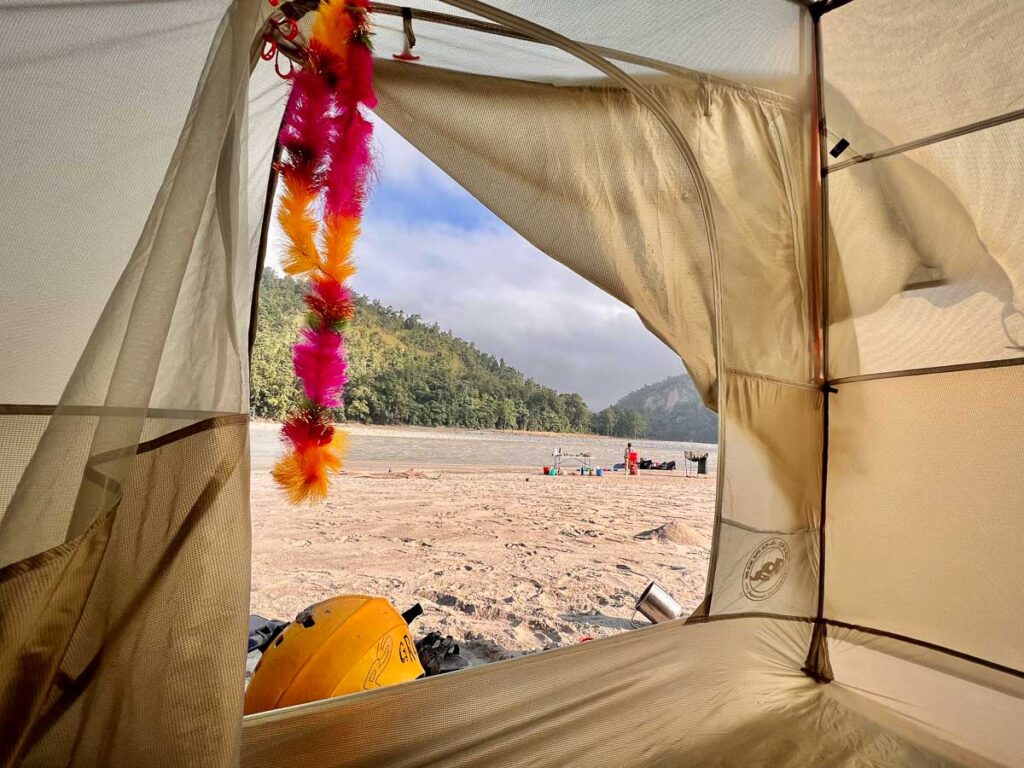 Looking out onto the river in a beach camping tent