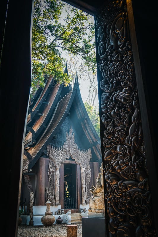 black temple chiang rai frontal view from within doorway