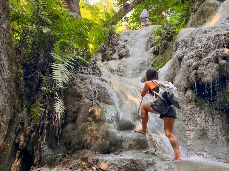 Cat Xu climbing up the side of sticky waterfalls