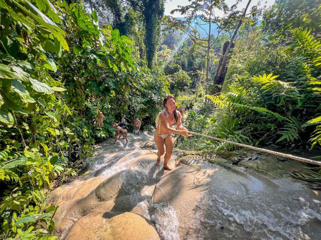 nomadicated climbing up the bua tong sticky waterfalls near chiang mai