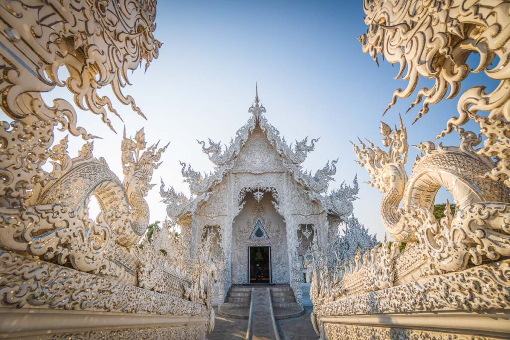 white temple chiang rai pov front in golden hour