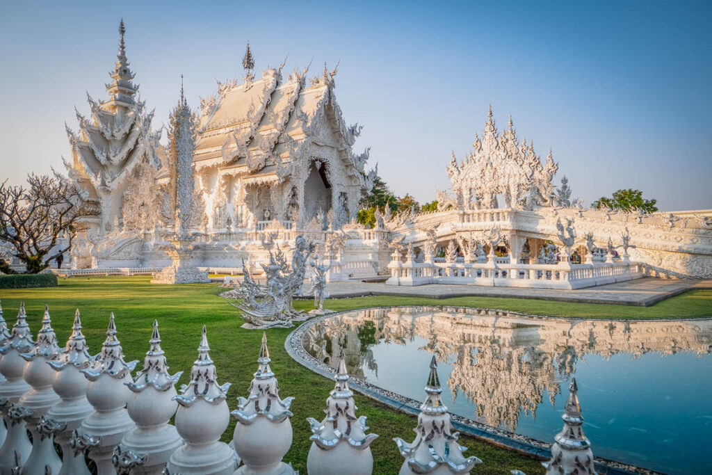 Wat Rong Khun pond side view in golden hour, one of southeast asia's most famous man-made landmarks