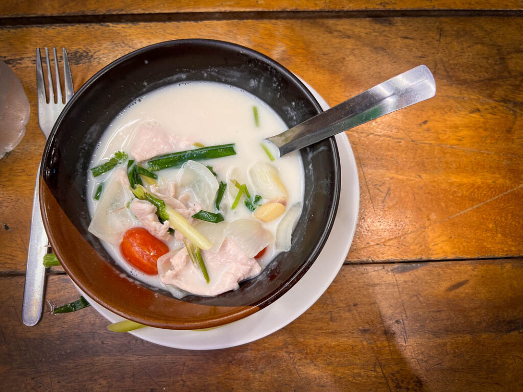 kom khai gai coconut soup is a common dish to prepare in chiang mai cooking classes