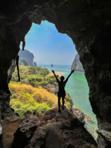 nomadicated marveling at the bat cave, one of the best things to do in railay beach, thailand