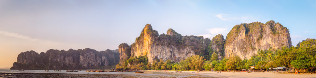 An panoramic shot of railay beaches limestone cliffs during golden hour