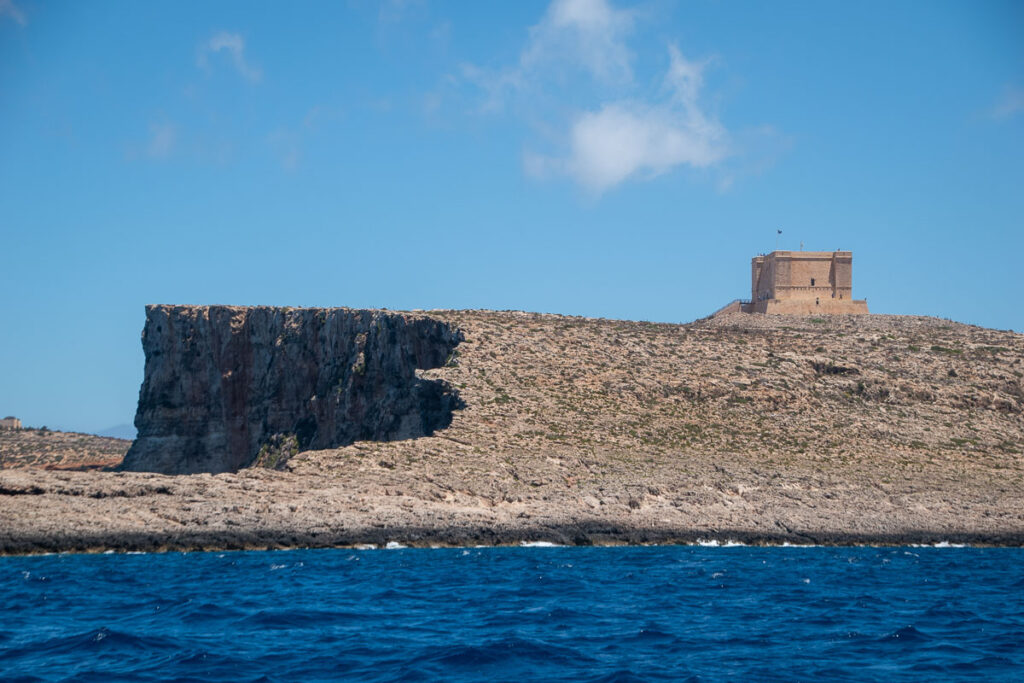 st. mays tower from a boat view on comino
