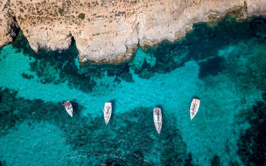 birds eye view of the boats of blue lagoon in comino island