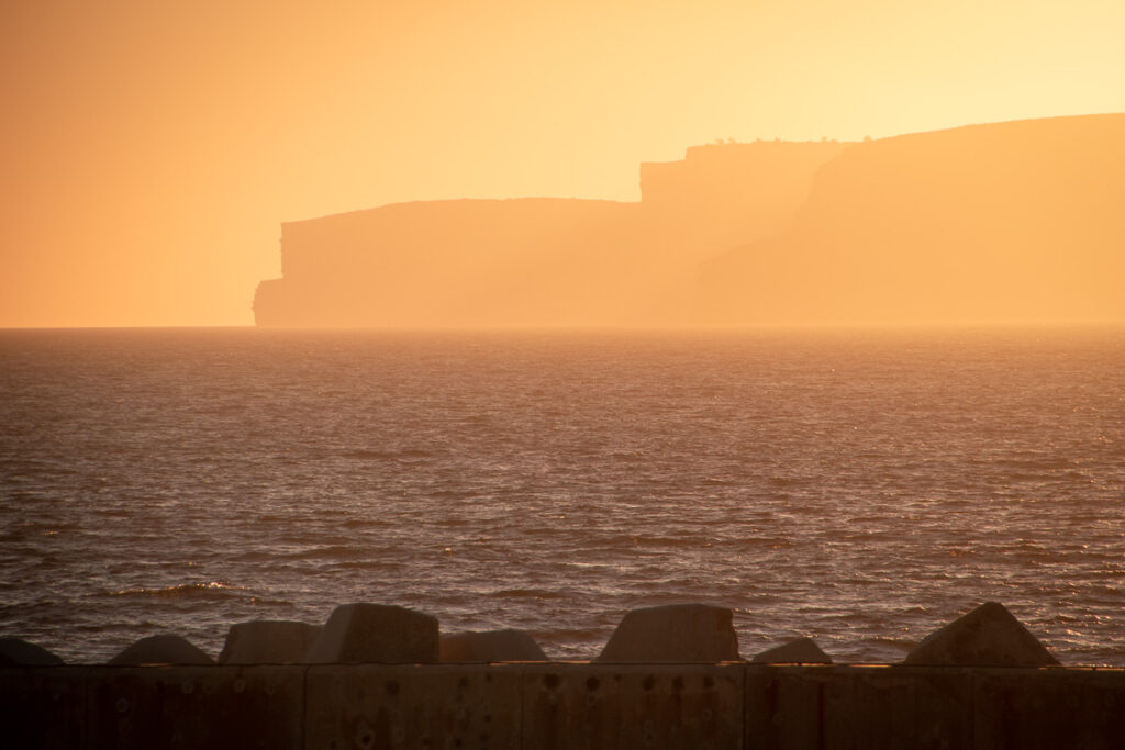 view of gozo island for the sunset from comino island