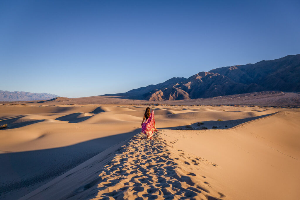 nomadicated with a red scarf posing in the mesquite sand dunes in death valley national park tour from las vegas 
