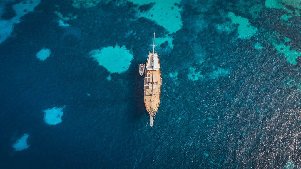 bird's eye view of sailboat on ocean in greece