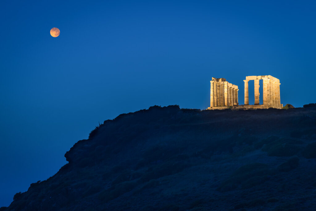 Moon rise above temple Poseidon on Sounion cape in Greece, a historical site near athens