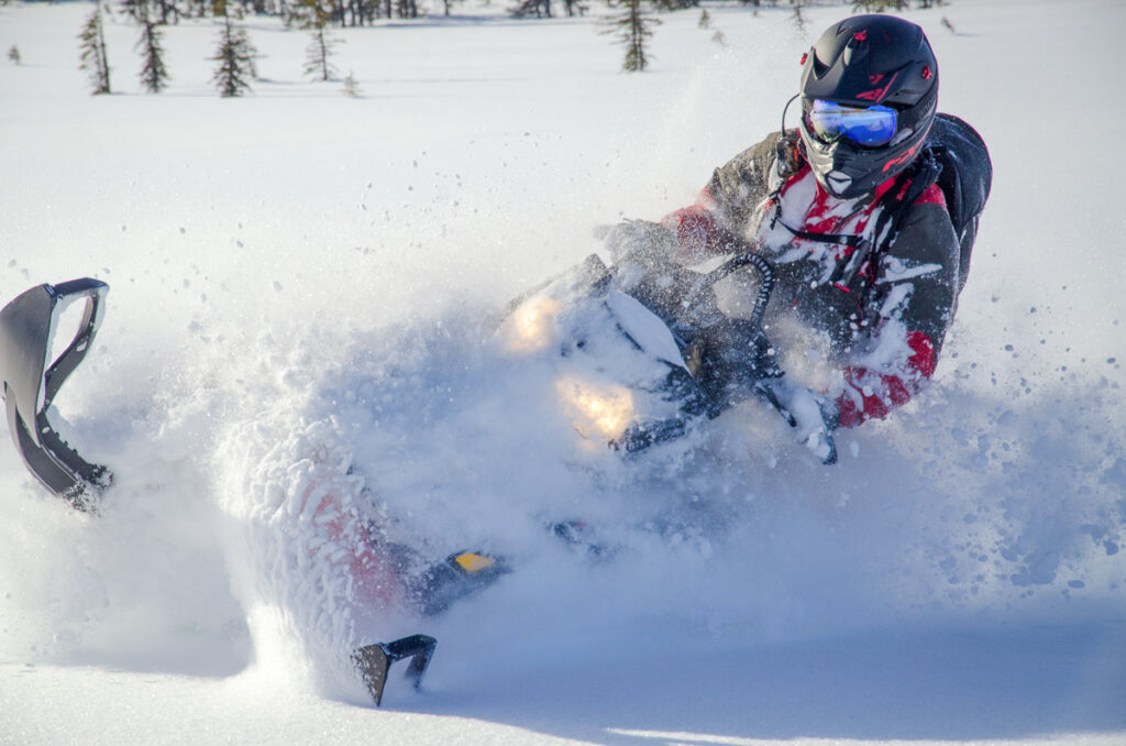 Backcountry snowmachine rider "sledder" on a winter yellowstone tour