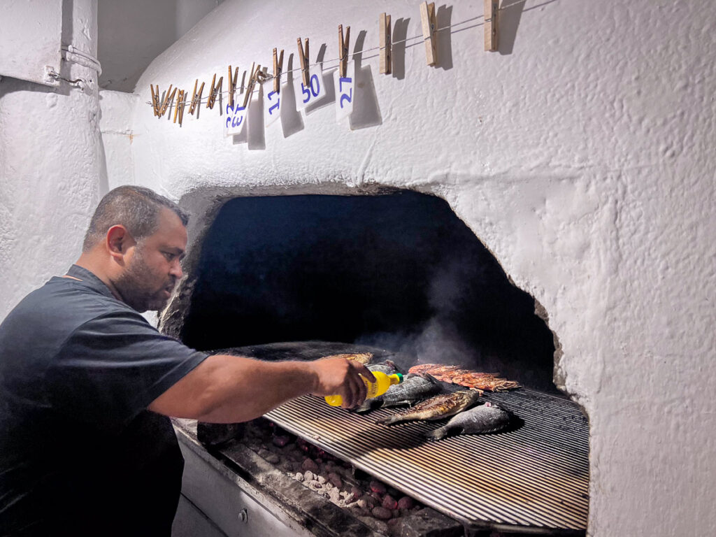 restaurant cooking fish in open air oven