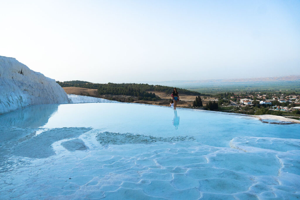 The glassy thermal pools of Pamukkale flowing through the mineral deposits