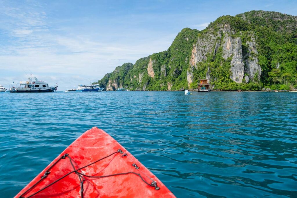kayaking to maya bay surrounded by the limestone cliffs