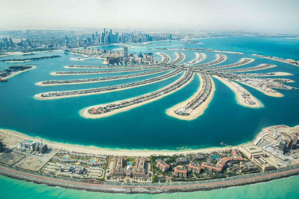 Aerial view of Palm Jumeirah man made island and Dubai Marina and JBR district on a sunny day. Dubai, UAE.