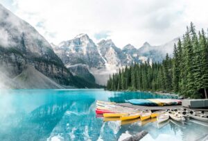 Moraine lake with small boats at morning spring time. Banff National park. Canada.