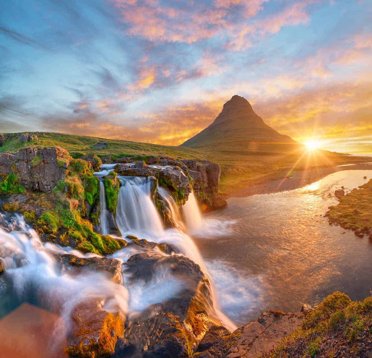 Beautiful landscape with sunrise on Kirkjufellsfoss waterfall and Kirkjufell mountain, Iceland, Europe