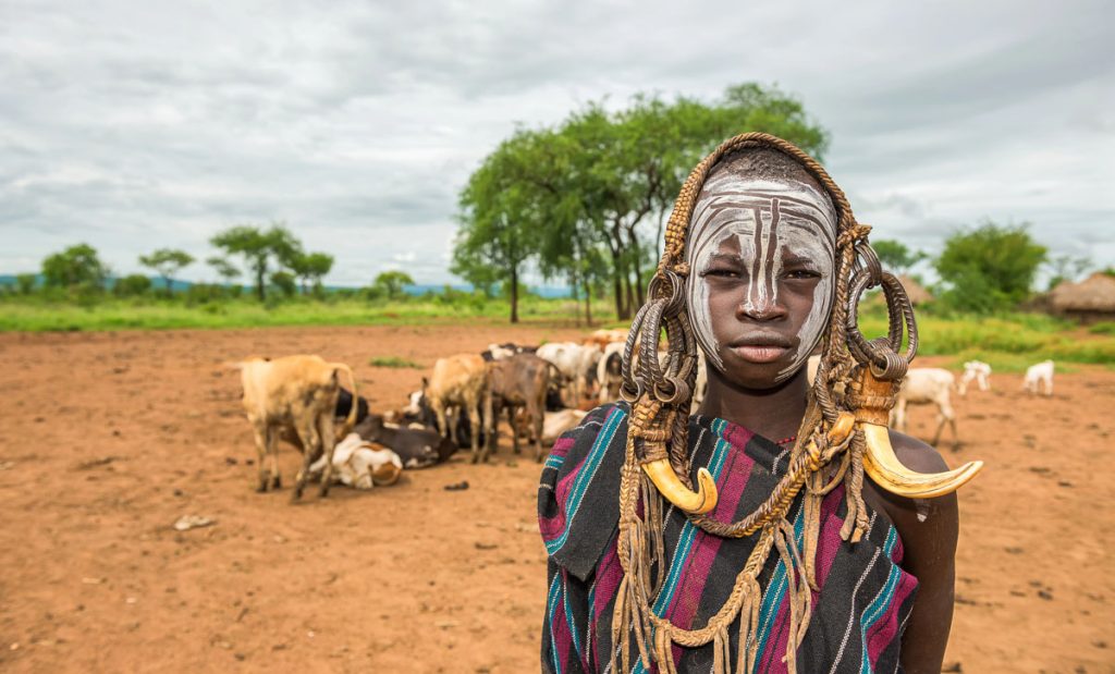 OMO VALLEY, ETHIOPIA Young boy from the African tribe Mursi with traditional horns in Mago National Park, Ethiopia.