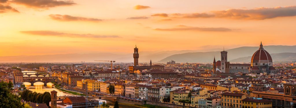 Florence city during golden sunset. Panoramic view to the river Arno, with Ponte Vecchio, Palazzo Vecchio and Cathedral of Santa Maria del Fiore (Duomo), Florence, Italy