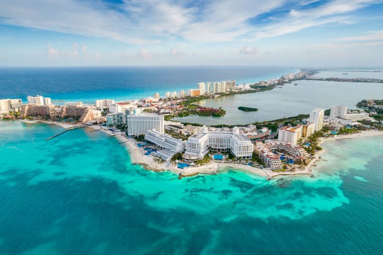 Aerial panoramic view of Cancun city hotel zone in Mexico. Caribbean coast landscape of Mexican resort with beach Playa Caracol and Kukulcan road. Riviera Maya in Quintana roo region on Yucatan Peninsula
