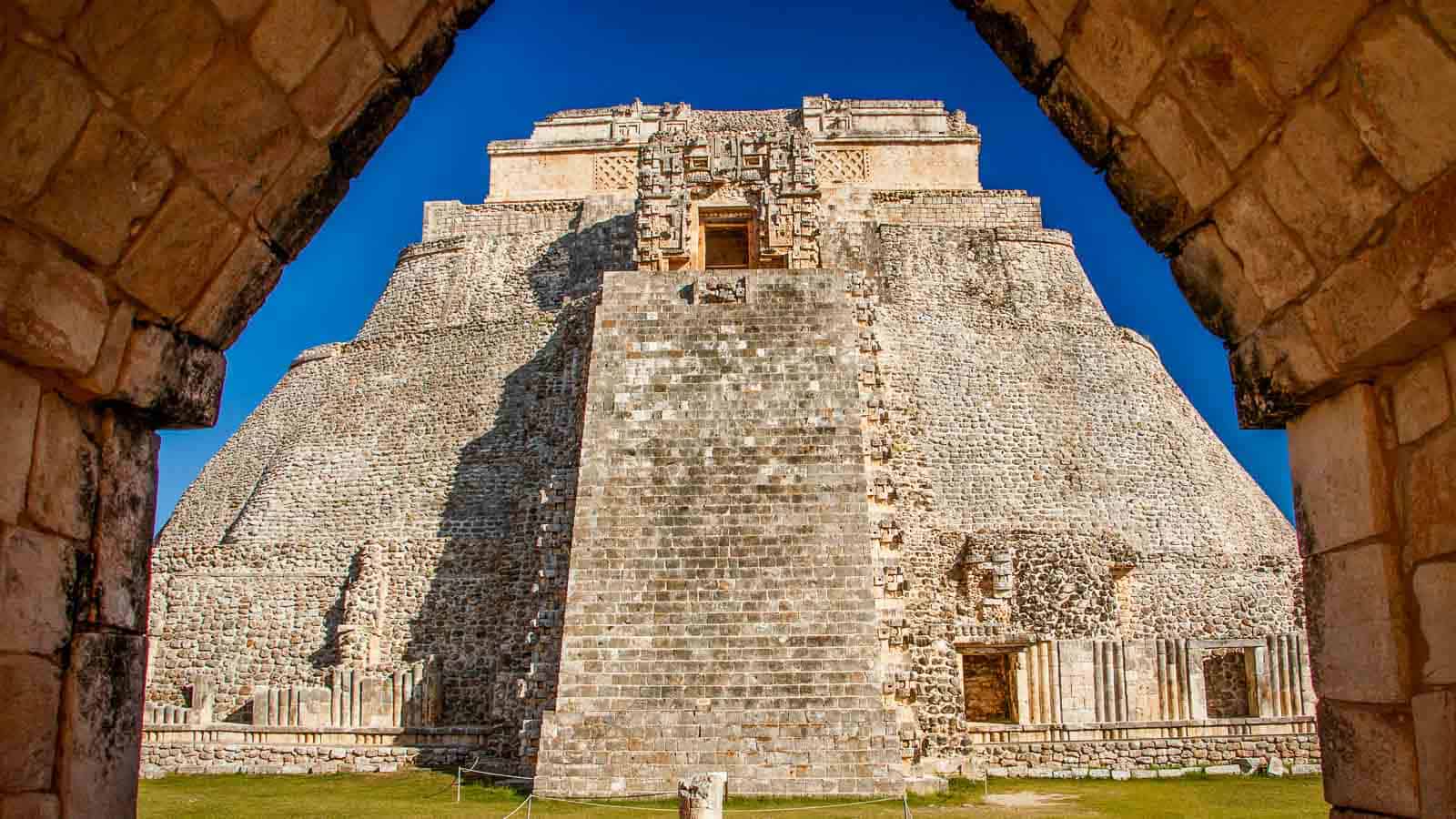 View of Uxmal palace framed by ancient stone gate, mayan treasure, touristic destination