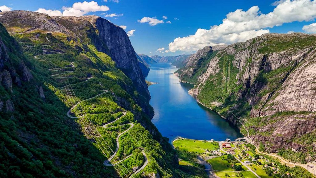 Experience breathtaking views of Lysefjord, Norway, where dramatic cliffs, winding roads, and tranquil waters create a perfect adventure for nature enthusiasts and outdoor lovers