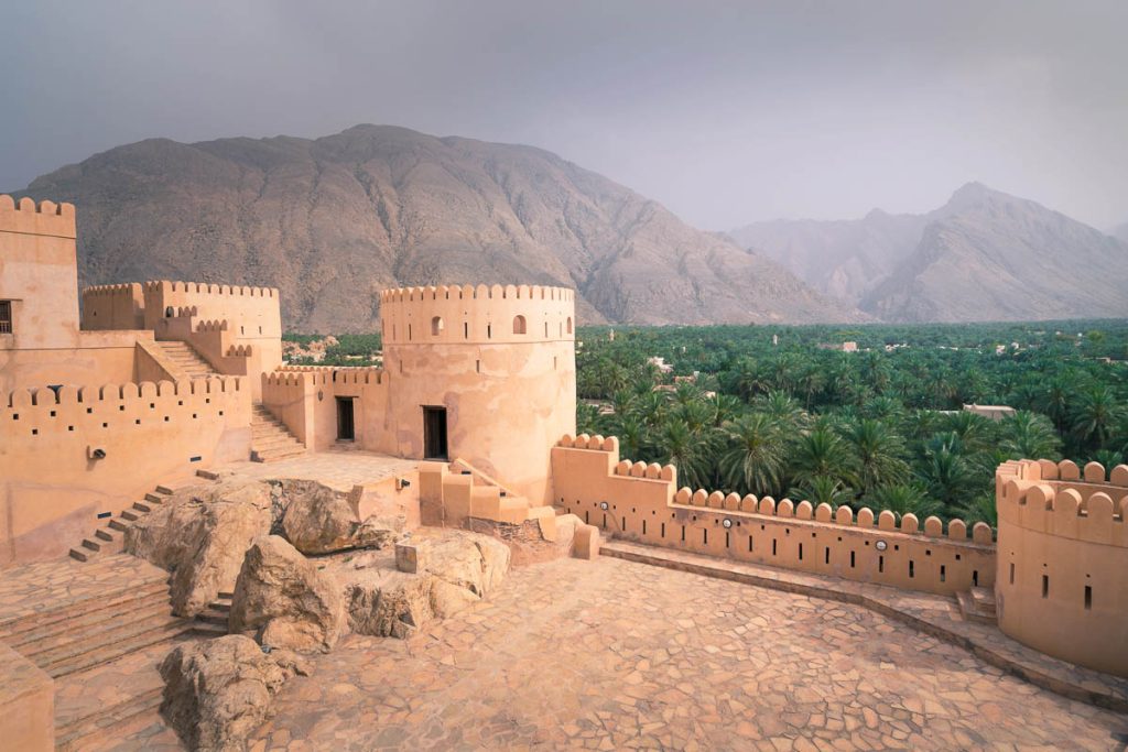 Nakhal,Oman - 04.01.2018: Yard inside the medieval arabian fort of Nakhal, Oman. Fortification walls, rock, stone floor, hazy sky. Medieval middle east castle. Arabia.