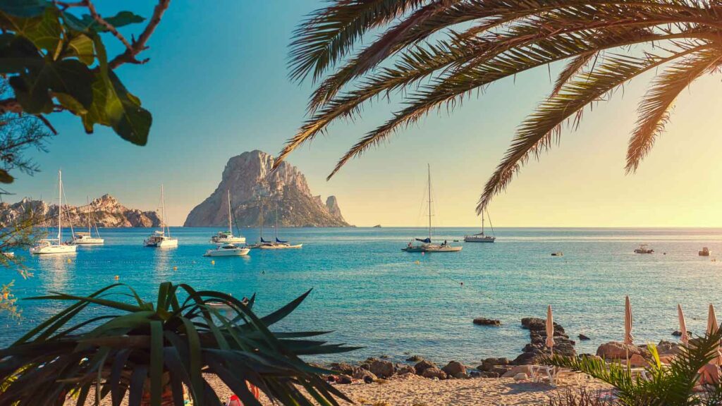 Cala d'Hort beach. Cala d'Hort in summer is extremely popular, beach have a fantastic view of the mysterious island of Es Vedra. Ibiza Island, Balearic Islands. Spain