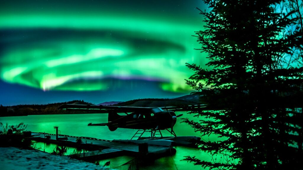 Canada, Yukon aurora northern lights with plane