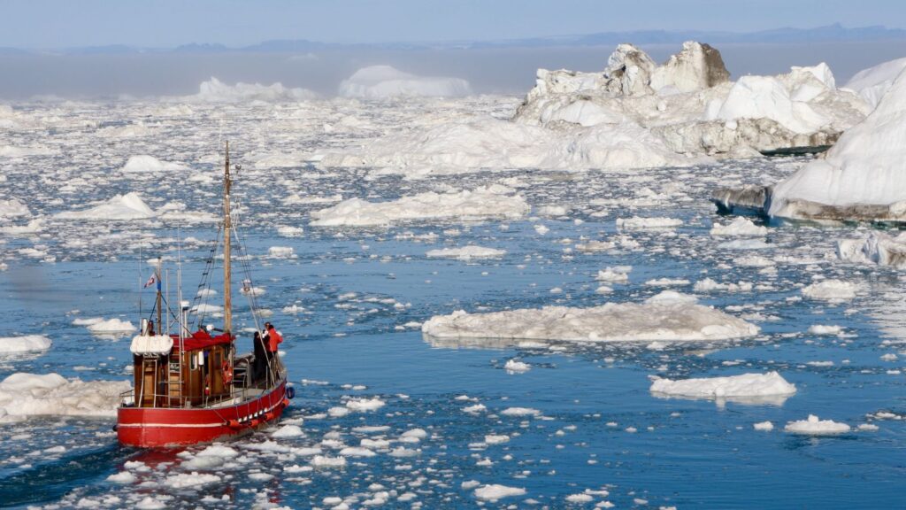 Greenland, Red ship traveling through the icy oceans