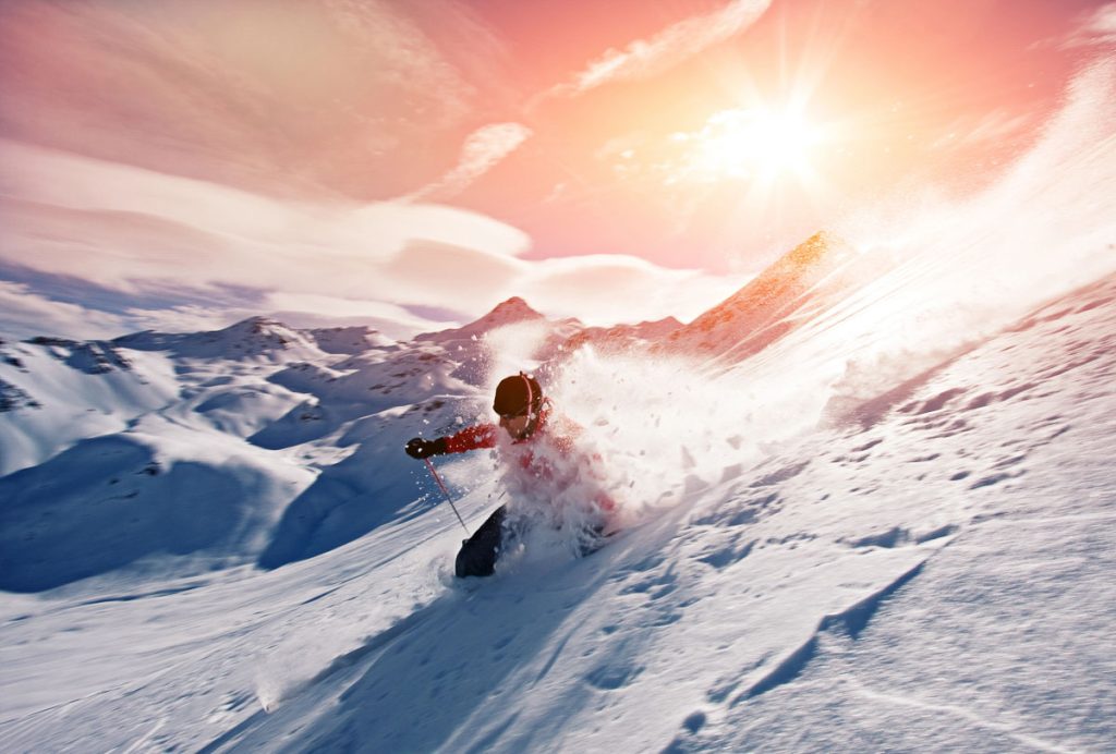 Young man skiing in powder snow
