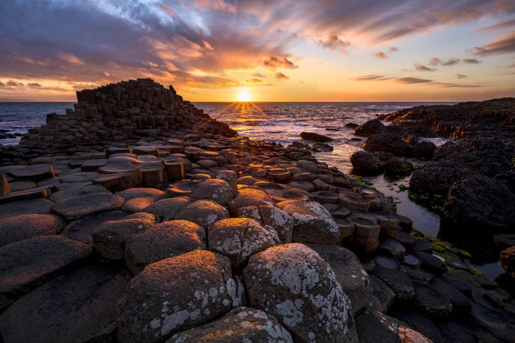 Northern Ireland, Giant’s Causeway, sunset over basalt column formations on the coast