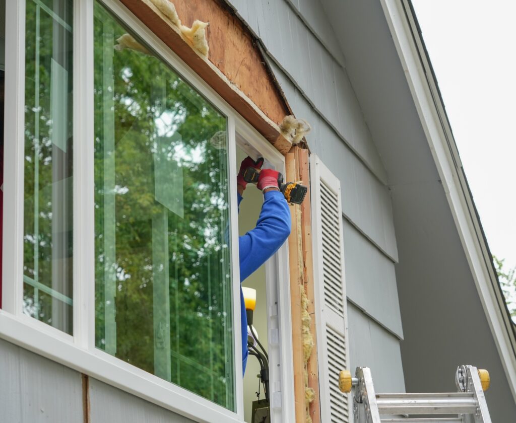 contractor working on replacing the window of the house