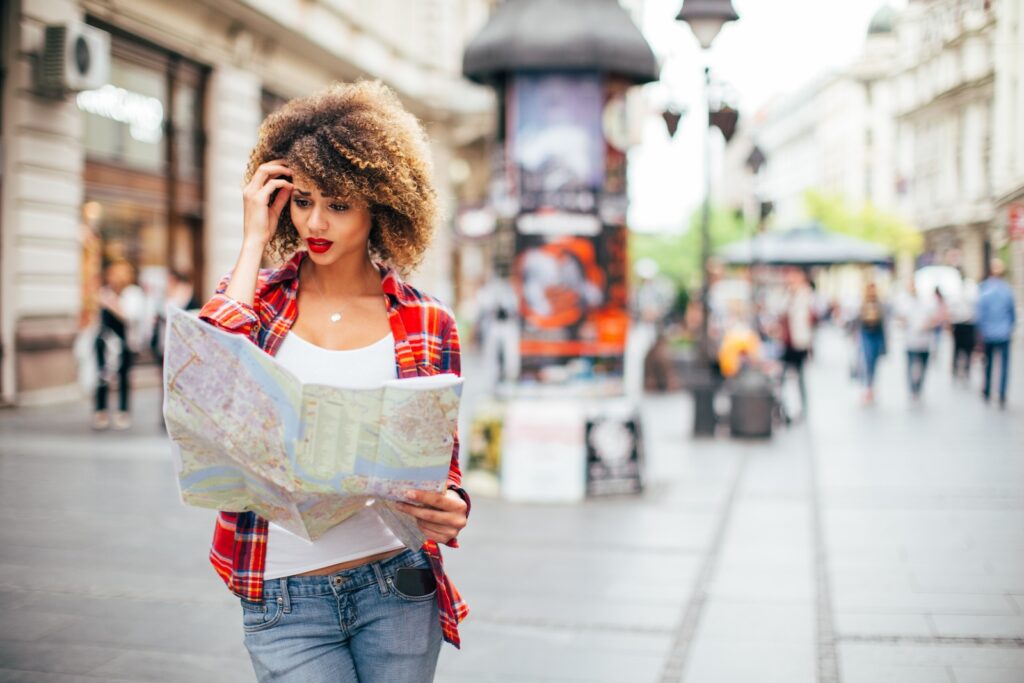 Young beautiful female traveler lost in the city