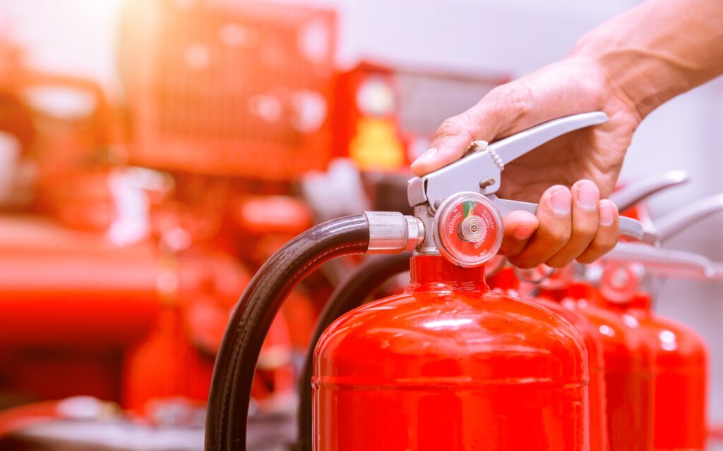 Close up Fire extinguisher and pulling pin on red tank.